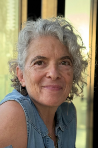 Ruthy Enez with beautiful grey curly hair. 